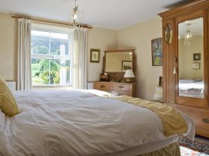 מיטה או מיטות בחדר ב-Harriets Cottage