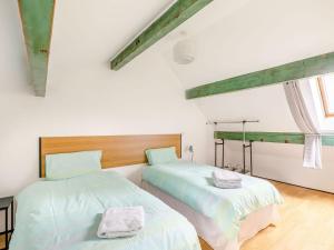 two beds in a room with white walls at Lister Suite - Uk38333 in Halifax
