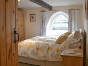 a bedroom with a bed and a window at The Old Chapel in Aysgarth