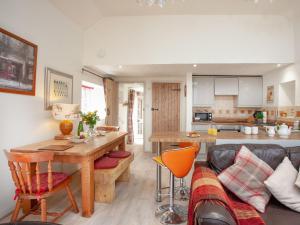 a kitchen and living room with a table and a couch at Tarka in Meeth
