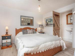 a bedroom with a large bed with a wooden headboard at Tarka in Meeth
