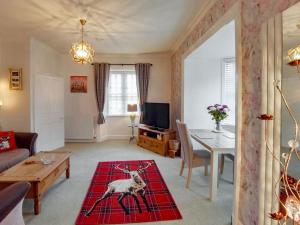 a living room with a dog on a rug at Toll House in Berwick-Upon-Tweed