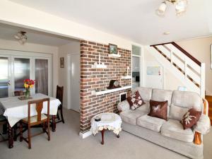 a living room with a couch and a brick wall at Kingsway Court in Seaford