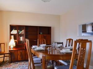 a dining room with a wooden table and chairs at No,3 Halford Farm in Halford
