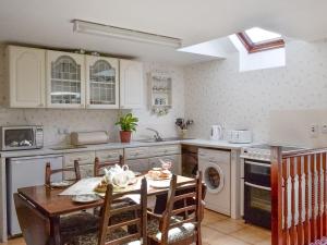 a kitchen with a table and a dining room at Low Cordorcan - Uk5891 in Bargrennan