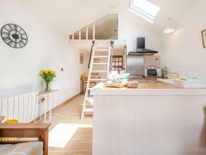a kitchen with white walls and a counter top at Nant Aeron in Talsarn