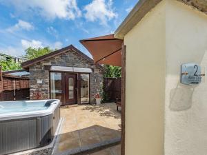 a backyard with a hot tub and a house at Nant Aeron in Talsarn