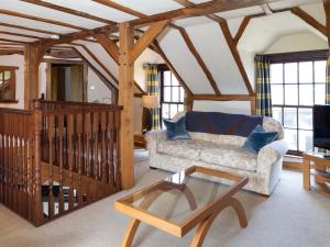 a living room with a couch and a coffee table at The Hayloft in Milnathort