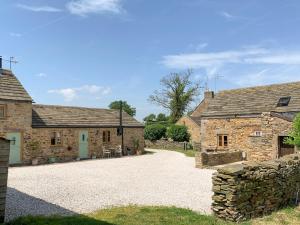 a view of two stone cottages with a driveway at Tawny Owl Barn in Barlow