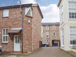 an exterior view of a brick building with a driveway at The Bishops Court in York