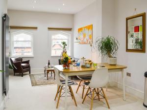 a living room with a dining room table and chairs at Ouse Retreat in York