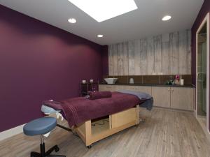 Cama en habitación con pared púrpura en Una Aurum 56, en Carbis Bay