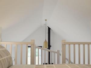 a bedroom with a bed and a stair railing at Badgers Sett Brook in Brook