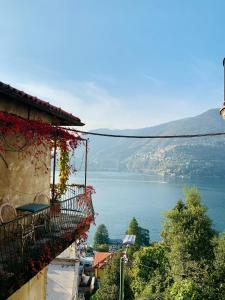 a building with a balcony with a view of a lake at VILLA Como, Jacuzzi Spa and Private Pool in Blevio