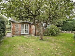 an apple tree in the yard of a house at Apple Tree Cottage in West Wittering