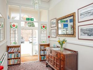 a home library with a dresser and bookshelves at Apartment Five - Uk39841 in Paignton
