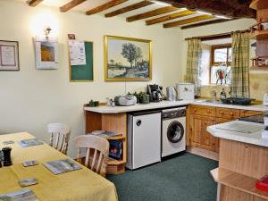 a kitchen with a washer and dryer in it at Cruck End - E3749 in Crackenthorpe