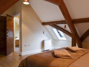 a bedroom with a large bed in a attic at Llaethdy-milkhouse in Talgarth