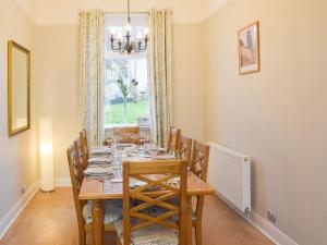 a dining room with a table and chairs and a window at Mainslea - Uk36872 in Dunure