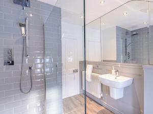 a bathroom with a glass shower and a sink at Well Strand in Rothbury