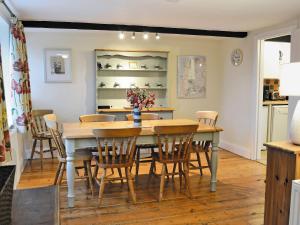 a kitchen and dining room with a table and chairs at Penhill Farm Cottage in Fremington