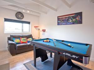 a living room with a pool table and a couch at Sea Salt Lodge in Torquay