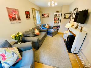 a living room with a couch and a tv at The Coach House - 26154 in Corbridge