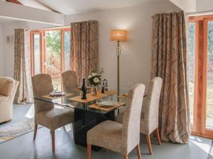 a dining room with a table and chairs at Haycart Barn in Long Stratton