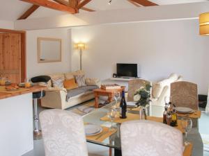 a living room with a couch and a table at Haycart Barn in Long Stratton