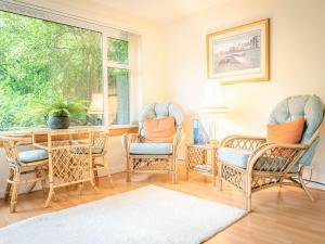 a dining room with chairs and a table and a window at Argyle View in Dunblane