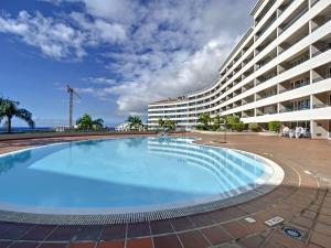 a large swimming pool in front of a large building at Monumental Ocean View by Atlantic Holiday in Funchal