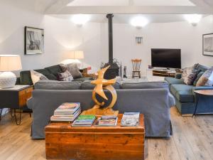 a living room with a couch and a table at Slowpool 