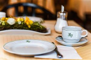a table with a plate and a coffee cup on it at Hotel Vienna beim Prater in Vienna