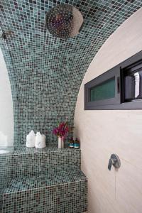 a bathroom with a shower with a tile wall at Saranda Boutique Hotel in Puerto Viejo
