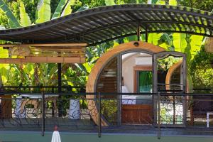 a small house with an arbor on a balcony at Saranda Boutique Hotel in Puerto Viejo