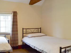 a bedroom with two beds and a window at Repton Cottage - 25348 in Findern