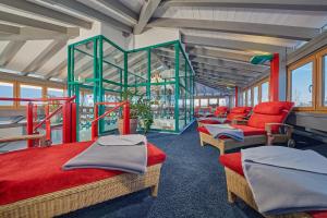 a room with four beds and red chairs in it at Kneipp- und Wellvitalhotel Edelweiss in Bad Wörishofen +45 photos