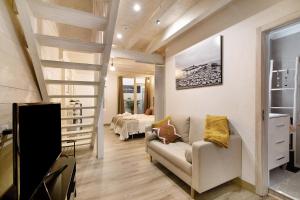 a living room with a staircase and a couch at Casa na Travessa in Faro