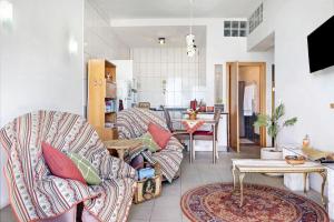 a living room with a couch and a table at Vila Morning Sun in Estreito da Calheta