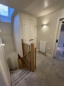 an empty room with a staircase and a door at Newly built house with elegant touches... in Todenham