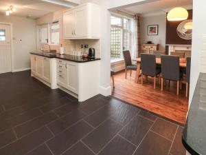 a kitchen and dining room with a table and chairs at Glenander in Bamburgh