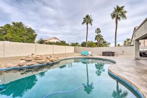 a swimming pool in a backyard with palm trees at Glendale Getaway Pool, Hot Tub and Ping-Pong Table! in Phoenix