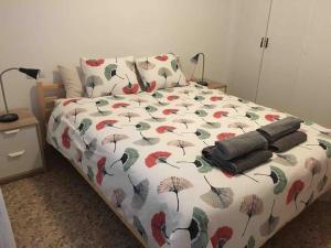 a bed with a blanket with umbrellas on it at Castellon Center Modern Spacious Apartment in Castellón de la Plana