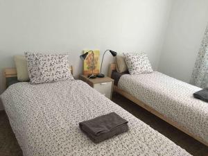 a bedroom with two beds and a bag on top of them at Castellon Center Modern Spacious Apartment in Castellón de la Plana