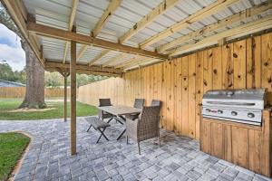 a patio with a grill and a table and chairs at Apopka Home with Yard and Grill Near Wekiwa Springs! in Apopka