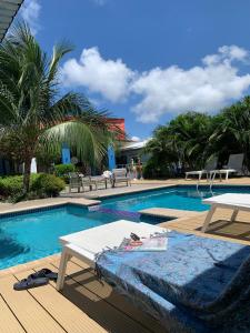 a swimming pool with a picnic table and a table at Lilu Apartments Curaçao in Willemstad