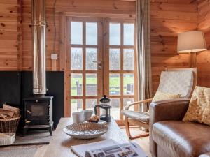 a living room with a wood stove and a couch at Dukes Wood - Ukc2193 in Caunton