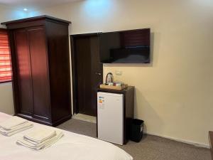 a room with a bed and a small refrigerator at Sultan Home in Wadi Musa