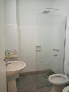 a bathroom with a sink and a toilet and a glass shower at Monoambiente con Patio Exelente ubicación en el Centro in Rosario