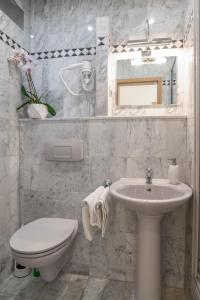 a white bathroom with a toilet and a sink at Villa Sladojević in Omiš +51 photos